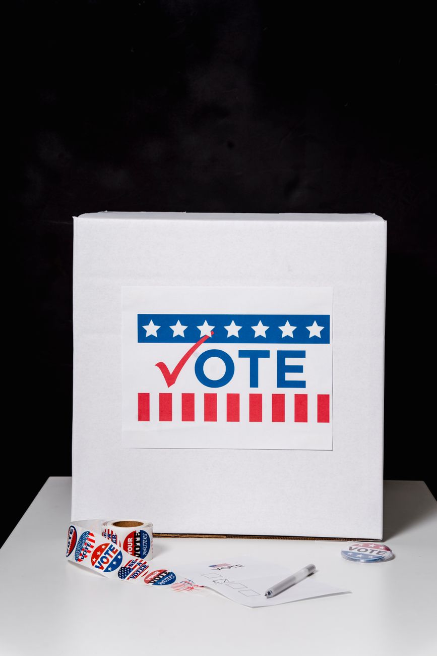 photo of white ballot box on the table
